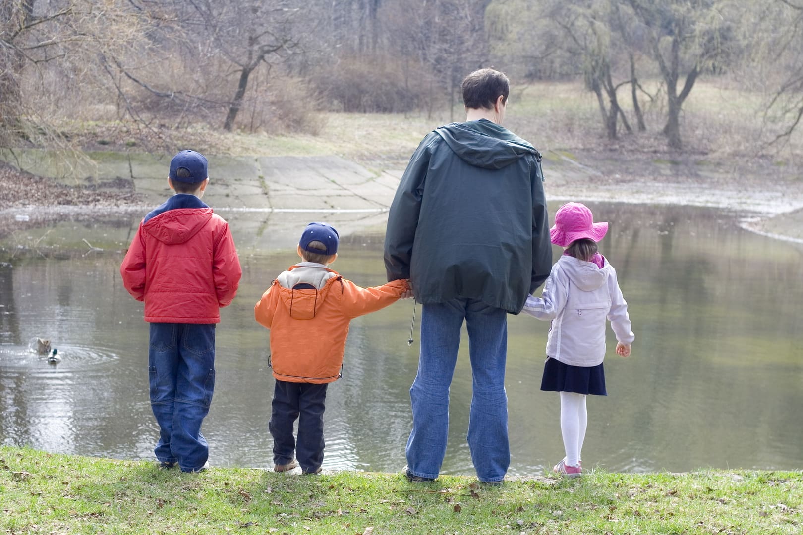 A man and two children standing next to each other.