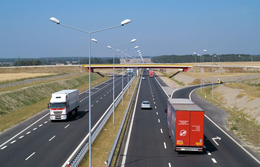 A highway with several vehicles driving on it.